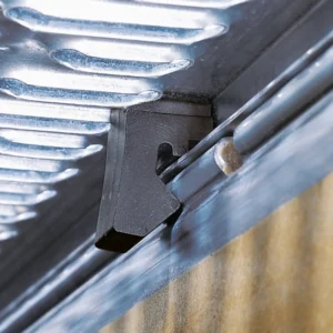 Close-up of a black plastic door guide attached to a metal track with a screw.
