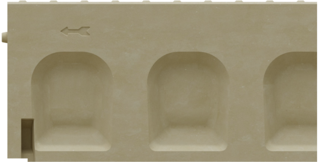 Beige plastic block with three rounded rectangular recesses and a small arrow mark on the top left edge.