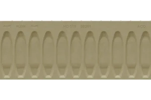 Close-up of a beige plastic component showing a row of rounded, oval cavities with 'FLOW' and arrows imprinted above, suggesting a mold or flow channel part.